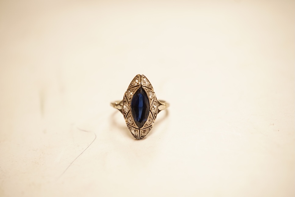 A 1920's style white metal, sapphire and diamond cluster set navette shaped ring, size G, gross weight 2.4 grams.